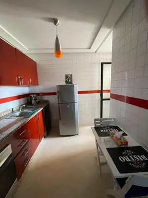 a kitchen with red cabinets and a stainless steel refrigerator at Stylish & Comfy Gem 5 Star Location Balcony in Marrakech