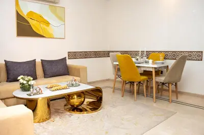 a living room with a couch and a table at Boho Haven Hivernage - Plein centre ville in Marrakech