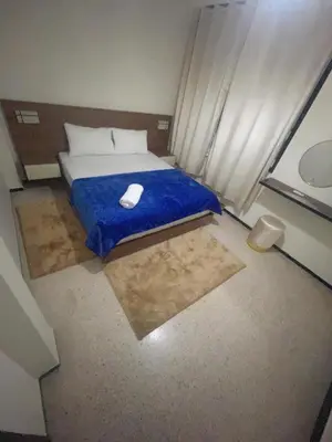 a bedroom with a bed with a mouse on a blue blanket at Your right choice in Marrakech