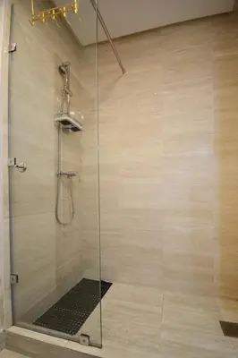 a shower with a glass door in a bathroom at Appartement Prestigia - Golf - Piscine - Restaurants in Marrakech