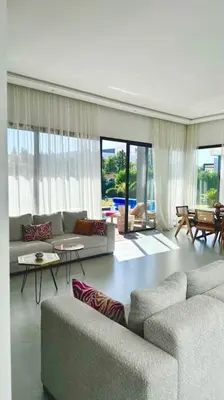 a living room with two couches and a table at Villa Alanaé piscine chauffée in Douar Bellouk