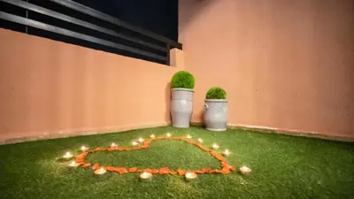 two plants in vases sitting on the grass at Home Lucini To Marrakech in Marrakech