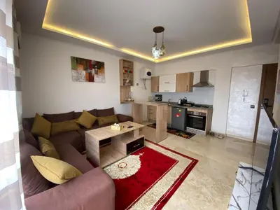 a living room with a couch and a table at نور 5 كليز in Marrakech