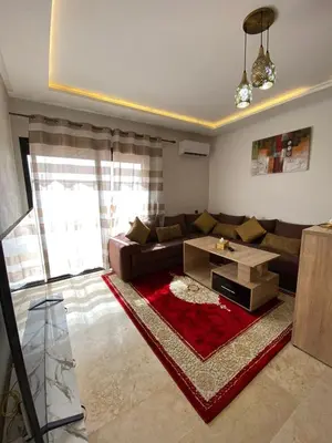 a living room with a couch and a coffee table at نور 5 كليز in Marrakech