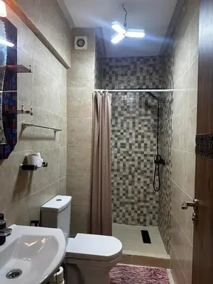 a bathroom with a shower and a toilet and a sink at نور 5 كليز in Marrakech