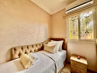a bedroom with a large bed with a window at Triplex spacieux et familial avec une vue panoramique in Marrakech