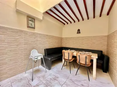 a dining room with a table and a couch at Triplex spacieux et familial avec une vue panoramique in Marrakech