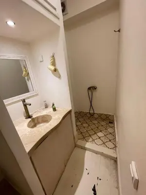 a bathroom with a sink and a shower at Diamant La Ville Rouge in Marrakech