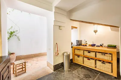 a kitchen with a counter and a table at Peaceful Oasis Authentic Riad in Marrakech