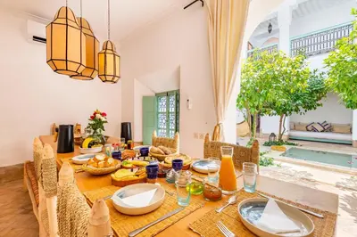 a dining room with a table with food on it at Peaceful Oasis Authentic Riad in Marrakech