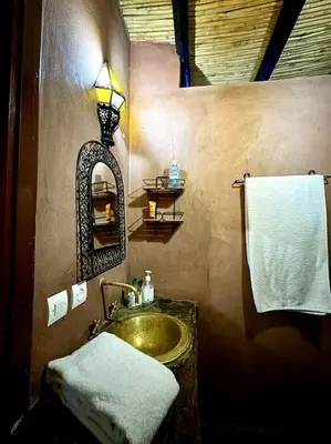 a bathroom with a sink and a mirror at 2 Habitaciones en magnifico riad in Marrakech