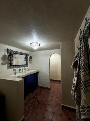 a bathroom with a sink and a mirror at 2 Habitaciones en magnifico riad in Marrakech