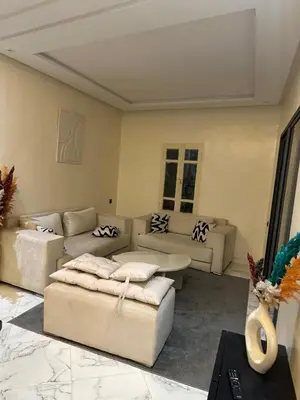 a living room with couches and a table at Maison meublé 3 pièces avec Piscine in Marrakech