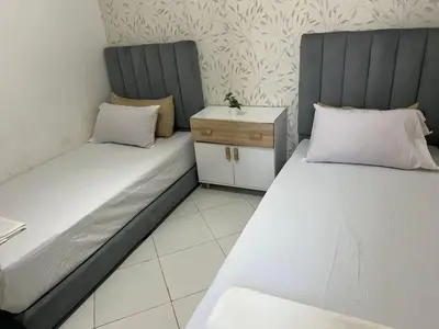 two beds sitting next to each other in a room at TerHouse in Marrakech