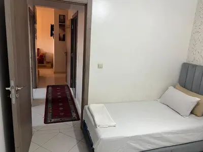 a small bedroom with a bed and a hallway at TerHouse in Marrakech
