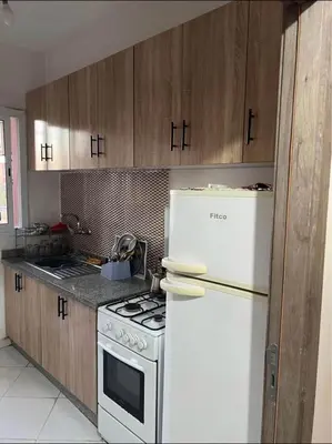 a kitchen with a stove and a white refrigerator at TerHouse in Marrakech