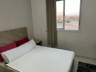 a bedroom with a white bed and a window at TerHouse in Marrakech
