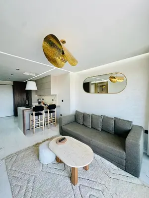 a living room with a couch and a table at Sompteux Appartement 1 chambre Piscine à Marrakech in Marrakech