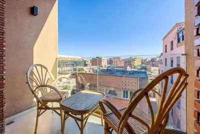 three chairs and a table on a balcony with a view at MARJANA Luxe appartement in Marrakech