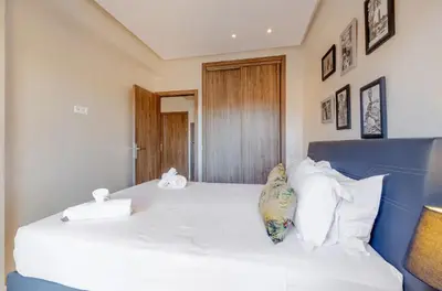 a bedroom with a large bed with white sheets and pillows at MARJANA Luxe appartement in Marrakech