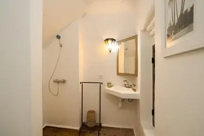 a white bathroom with a sink and a mirror at Riad Banafsaj - Exclusif - 20mn de Jamaa Al Fnaa in Marrakech