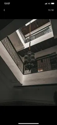 a chandelier hanging from a ceiling in a room at Tourist Riad in Marrakech