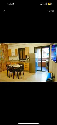 a kitchen with a table and a refrigerator in it at Love studio in Marrakech