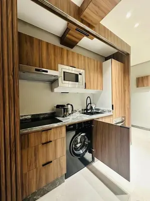 a kitchen with a stove and a microwave at Sublime Appartement 1 chambre WIFI à Marrakech in Marrakech