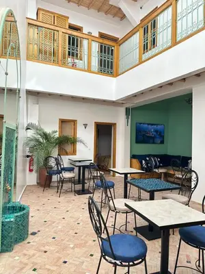 a room filled with tables and chairs at Riad Madinina in Marrakech