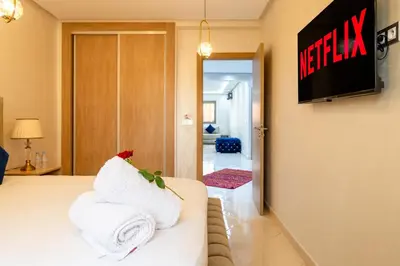 a hotel room with a bed and a television at L'Havre de paix de Guéliz au Coucher de Soleil in Marrakech