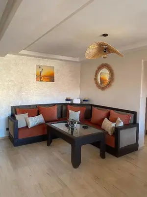 a living room with a couch and a coffee table at Appartement 2 Chambre au Coeur de gueliz Marrakech in Marrakech