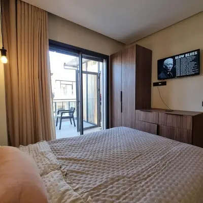 a bedroom with a bed and a sliding glass door at Appartement à louer in Marrakech