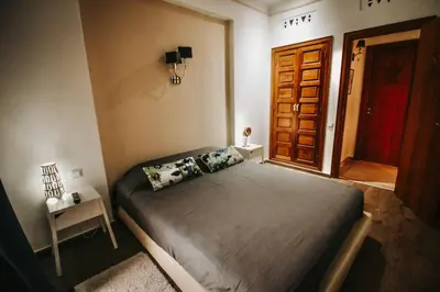 a bedroom with a bed in a room with a door at Logement confortable et chic, Gueliz, Carre Eden in Marrakech