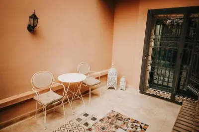 a room with a table and chairs and a window at Logement confortable et chic, Gueliz, Carre Eden in Marrakech