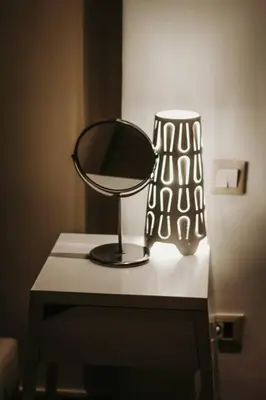 a table with a mirror and a lamp on it at Logement confortable et chic, Gueliz, Carre Eden in Marrakech