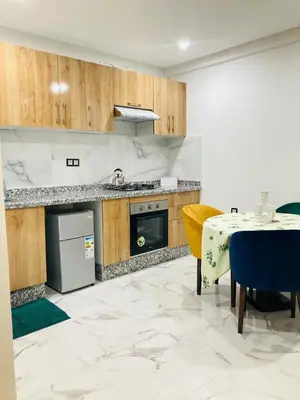 a kitchen with a table and a sink and a stove at Magnifique appartement à Marrakech in Marrakech