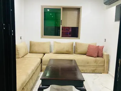 a living room with a couch and a coffee table at Magnifique appartement à Marrakech in Marrakech