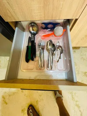 a drawer in a cabinet with utensils in it at Super appartement in Marrakech
