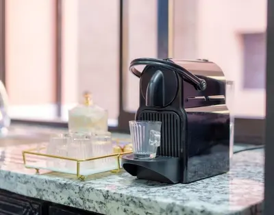 a black coffee maker with a glass on a counter at Oasis exclusive avec piscine dans le centre-ville in Marrakech
