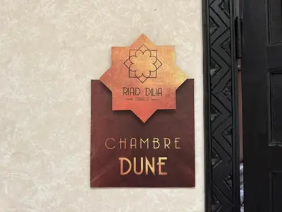 a sign on a door that reads chambre dume at Riad Dilia in Marrakech