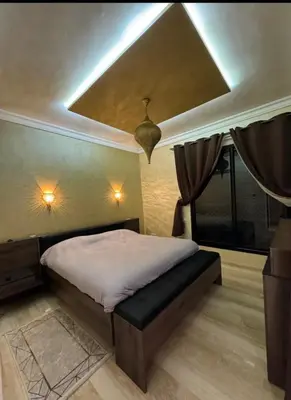 a bedroom with a bed with a coffered ceiling at Charmant villa au cœur de la palmeraie in Douar Caïd Layadi