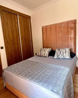 a bed with two pillows on it in a bedroom at HIVER NAGE home in Marrakech