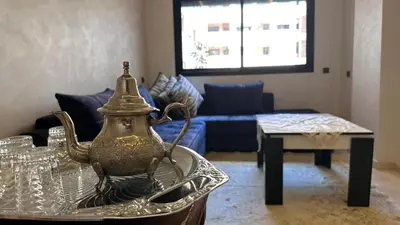 a living room with a tea pot on a glass table at HIVER NAGE home in Marrakech