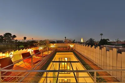 a view of a rooftop of a building at night at Riad dar Tayri in Marrakech
