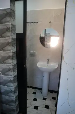 a bathroom with a sink and a mirror at Charming Medina Apartment in Marrakech