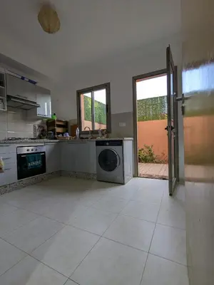 a kitchen with a washing machine in the middle at Janat House in Marrakech