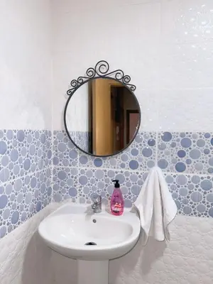 a bathroom with a sink and a mirror at Appartement Xénon in Marrakech