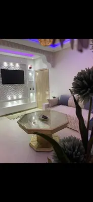 a living room with a table and a couch at Marrakech Les portes de gueliz 2 immeuble 4 appartement 29 in Marrakech
