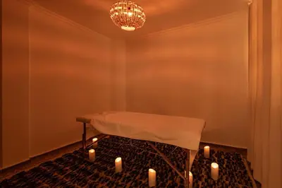 a room with a table with candles on the floor at La Villa d'Oz pour 12 personnes Golf Amelkis in Marrakech