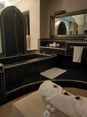a bathroom with a large mirror and a white towel at Riad shéhérazade Marrakech in Marrakech